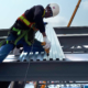 construction worker drilling metal
